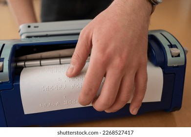 Blind man using braille typewriter.  - Shutterstock ID 2268527417