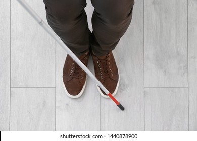 Blind Person With Long Cane Standing Indoors, Top View