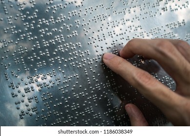 Blind person reading braille text