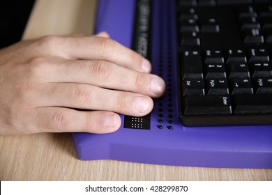 Blind Person Using Computer With Braille Computer Display And A Computer Keyboard. Blindness Aid, Visual Impairment, Independent Life Concept.
