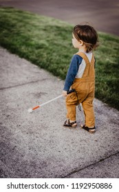 Blind Or Visually Impaired Child/Kid/Toddler/Preschooler/Boy Walking Through Neighborhood With Long White Cane; Back To Camera, #1