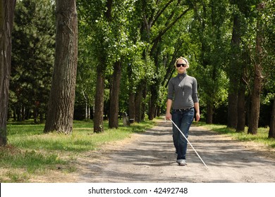Blind Woman Walking In A Park