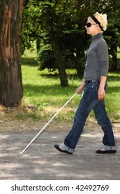 Blind Woman Walking In A Park