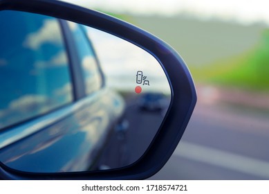 blind zone monitoring sensor on the side mirror of a modern car.