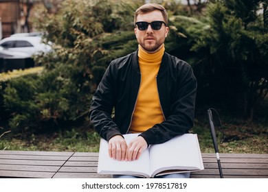 Blinded Man Reading By Touching Braille Book