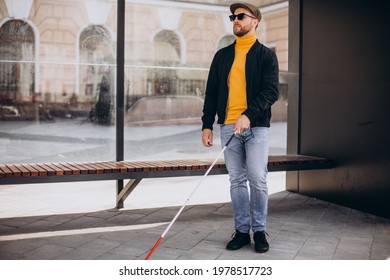 Blinded Man Waiting For Bus At A Bus Station