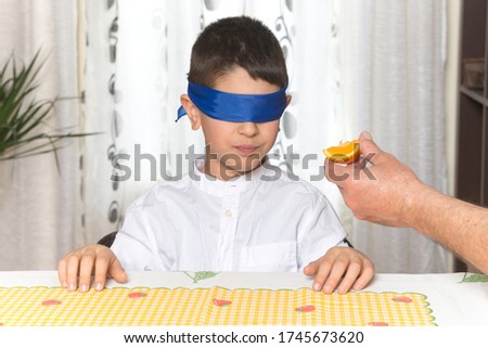 Image, Stock Photo Young child savoring a blue lollipop enthusiastically