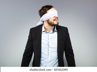 Blindfolded Man Trying To Hear Something