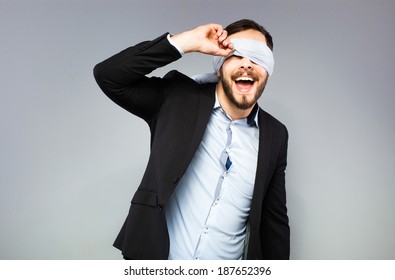 blindfolded man trying to see something