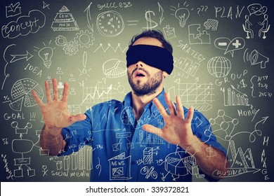 Blindfolded Young Business Man Searching Walking Through Complicated Social Media Financial Data Plan. Sightless Entrepreneur Analyst Managing Corporate Unknown  Financial Economy Risk Concept 