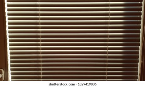 Blinds cover the window from the bright sunlight
