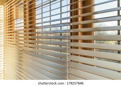 Blinds in a home catching the sunlight