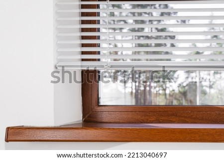 Blinds horizontal and Window with window sill.