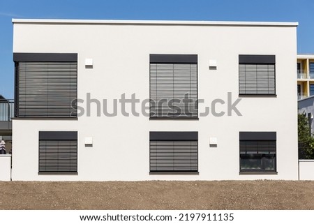 Blinds on Windows of Modern House. Modern Exterior Facade of Apartment Building with Roller Shutters and Flat Roof. 
