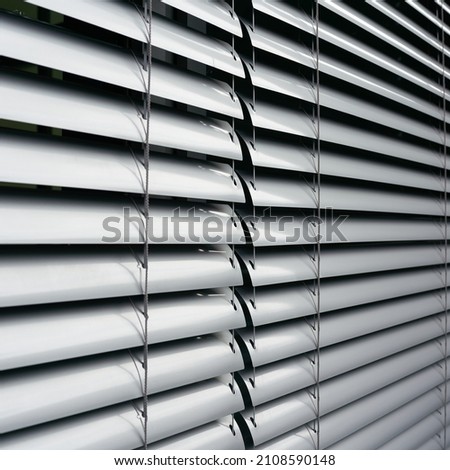     Blinds as sun protection on the window of an office building in Berlin in Germany                            
