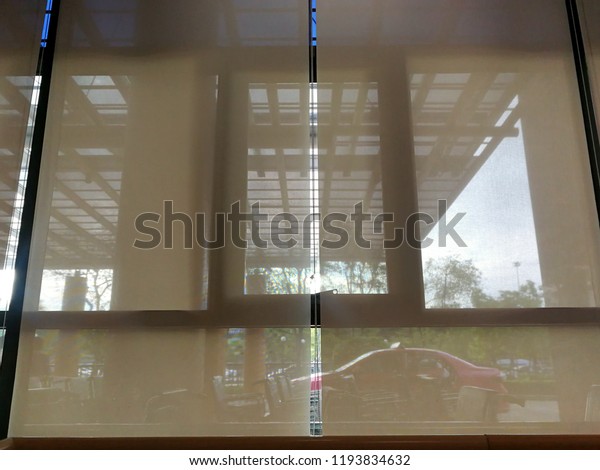 Blinds window\
decoration,Blinds window of building  with sunrise in morning that\
have car of taxi stopping on garden background, view of blind with\
rising sun on park\
background