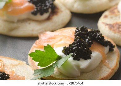 Blini With Caviar And Smoked Salmon On Table