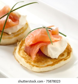 Blini Topped With Smoked Salmon And Sour Cream.