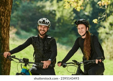 A blissful couple, adorned in professional cycling gear, enjoys a romantic bicycle ride through a park, surrounded by modern natural attractions, radiating love and happiness - Powered by Shutterstock