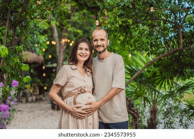 A blissful scene in the park as a radiant pregnant woman after 40 and her loving husband after 40, cherish the joy of parenthood together, surrounded by nature's serenity - Shutterstock ID 2345573955