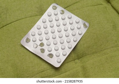 Blister With Small White Pills On A Green Background