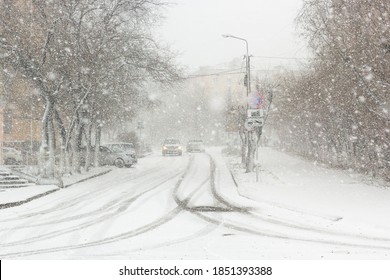 Blizzard, mist and snowfall in city, cars on sleet road, poor visibility, winter bad weather - Shutterstock ID 1851393388