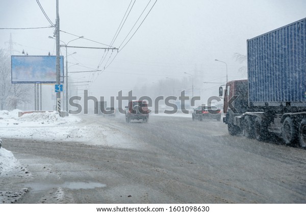 Blizzard on\
the road and poor visibility in the\
city.