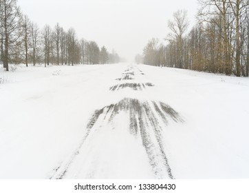 A Blizzard. Straight Road Covered With Snow