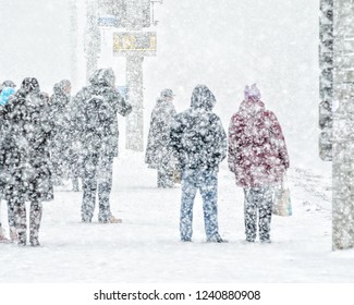 Blizzard in an urban environment. People on bus stop in snowfall. Abstract blurry winter weather background - Shutterstock ID 1240880908