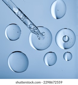 Blobs of gel or thick liquid resembling hyaluronic acid or keratin. Dropper with bubbles in scientific background. Bubble textures and a pipette.  - Powered by Shutterstock