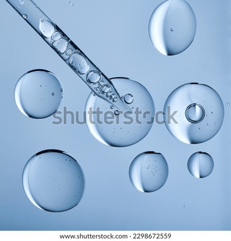 Blobs of gel or thick liquid resembling hyaluronic acid or keratin. Dropper with bubbles in scientific background. Bubble textures and a pipette. 