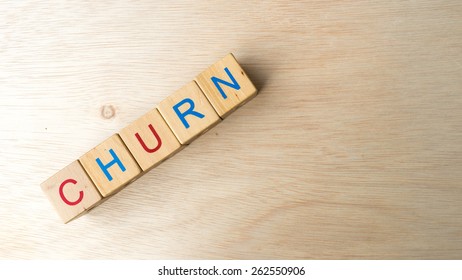 Block of alphabet letters forming the word CHURN on wooden surface. Concept of common marketing business terms. Slightly defocused and close-up shot. Copy space. - Shutterstock ID 262550906