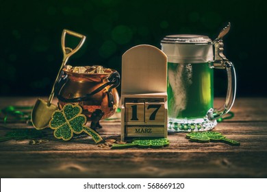 Block calendar for St Patrick's Day, March 17, with green beer and pot of gold, on wooden background. - Powered by Shutterstock