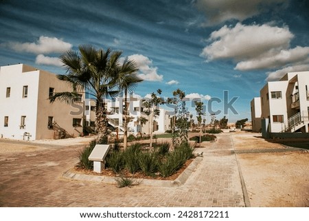Block of flats on desert. Negev desert architecture. Living area surrounded with sand. Israel landscape. Home on desert. Houses in Israel.