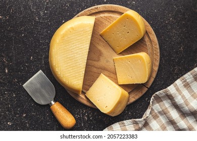 Block Of Hard Cheese On Cutting Board. Top View.