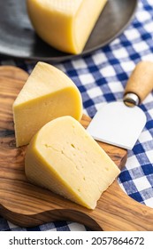 Block Of Hard Cheese. Sliced Cheese On Cutting Board.