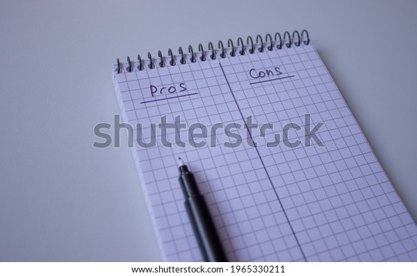 Block Notes with a metal spring and a\
marker, the sheet is divided in half with a vertical line, at the\
top \