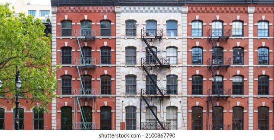 Block Of Old Apartment Buildings With Windows And Fire Escapes In The Tribeca Neighborhood Of New York City NYC