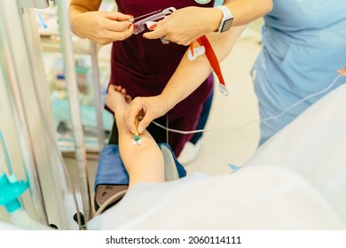 Block The Pain. Close Up Of Catheter With A Syringe In Hand Of Patient Lying On An Operating Table. The Process Of Surgery Under General Anesthesia. Preparation For Caesarean.