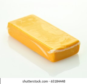 A Block Of Sharp Cheddar In A Vacuum Package