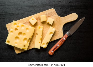 Block Of Tasty Cheese On Cutting Board. Top View.