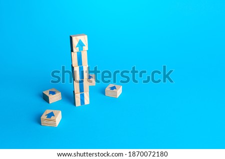 Block tower with arrows. Business growth and development concept. Achieve success. Building career advancement, improving skills. Goal achievement. Progress and movement forward. Self improvement