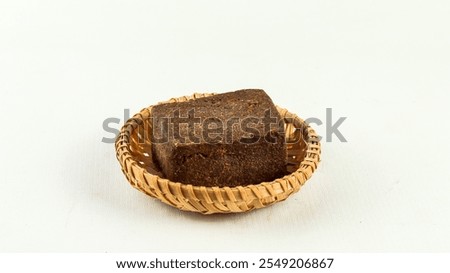 A block of traditionally made shrimp paste on white background

