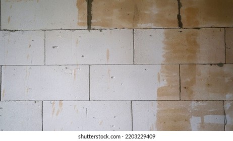 Block Wall, Primed. Industrial Background. Structural Plaster On The Wall. Wall With Yellow Primer.