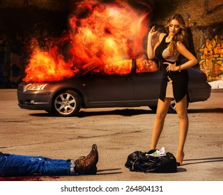 Blockbuster. Girl With Posh Figure Stands Over A Bag Full Of Money EUR Amid Exploding Car. Outdoors