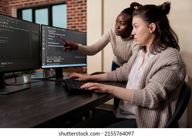 Blockchain engineer pointing out mistake in network security software line code. Cybernetics developers engineering system updates and processing data blocks uploaded by artificial intelligence.