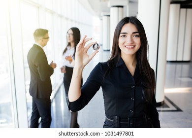 Blockchain and investment concept. Business woman leader holding litecoin in front of his team on office.
