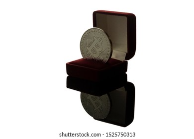 blockchain mining technologies for cryptocurrency. a silver bitcoin lies in a wedding ring box as a gift on the wedding day, an illustration of a physical bitcoin. isolate on a white background.