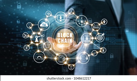 Blockchain technology concept. Businessman holding text blockchain in hand with icon networking connection on blue security and digital background