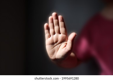 Blocking prohibiting gesture, hand outstretched with palm raised, saying no. - Powered by Shutterstock